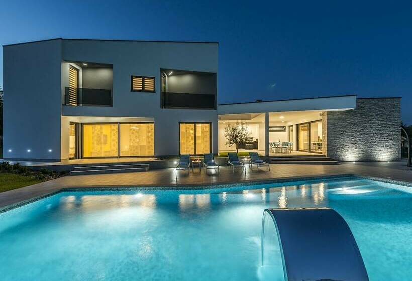 A Modern Luxury Villa With A Crystalclear Swimming Pool And Cultivated Garden