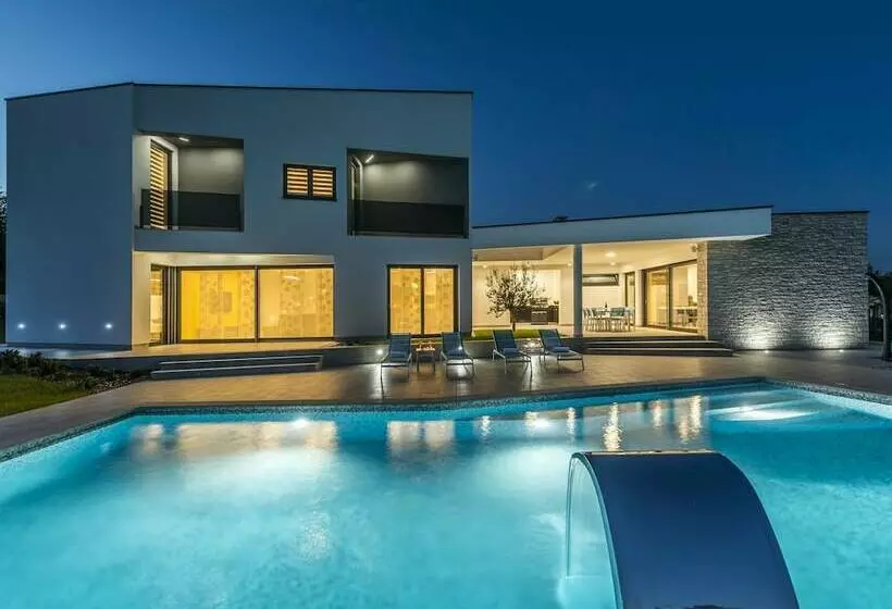 A Modern Luxury Villa With A Crystalclear Swimming Pool And Cultivated Garden