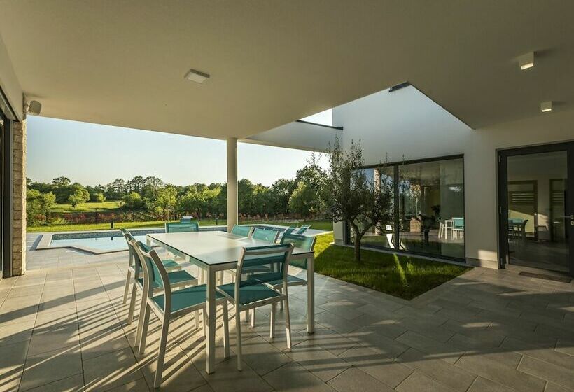 A Modern Luxury Villa With A Crystalclear Swimming Pool And Cultivated Garden