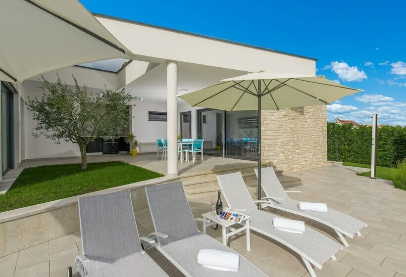 A Modern Luxury Villa With A Crystalclear Swimming Pool And Cultivated Garden