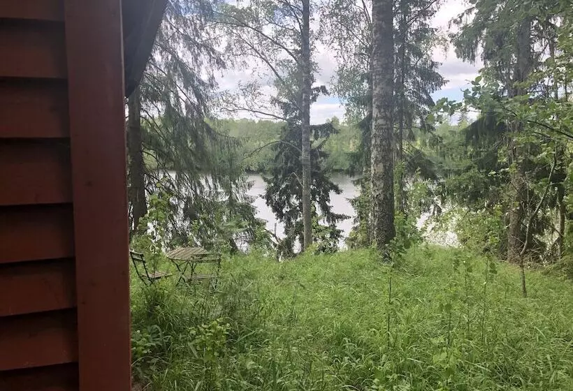 Tiny Hut In The Forest Overlooking The River